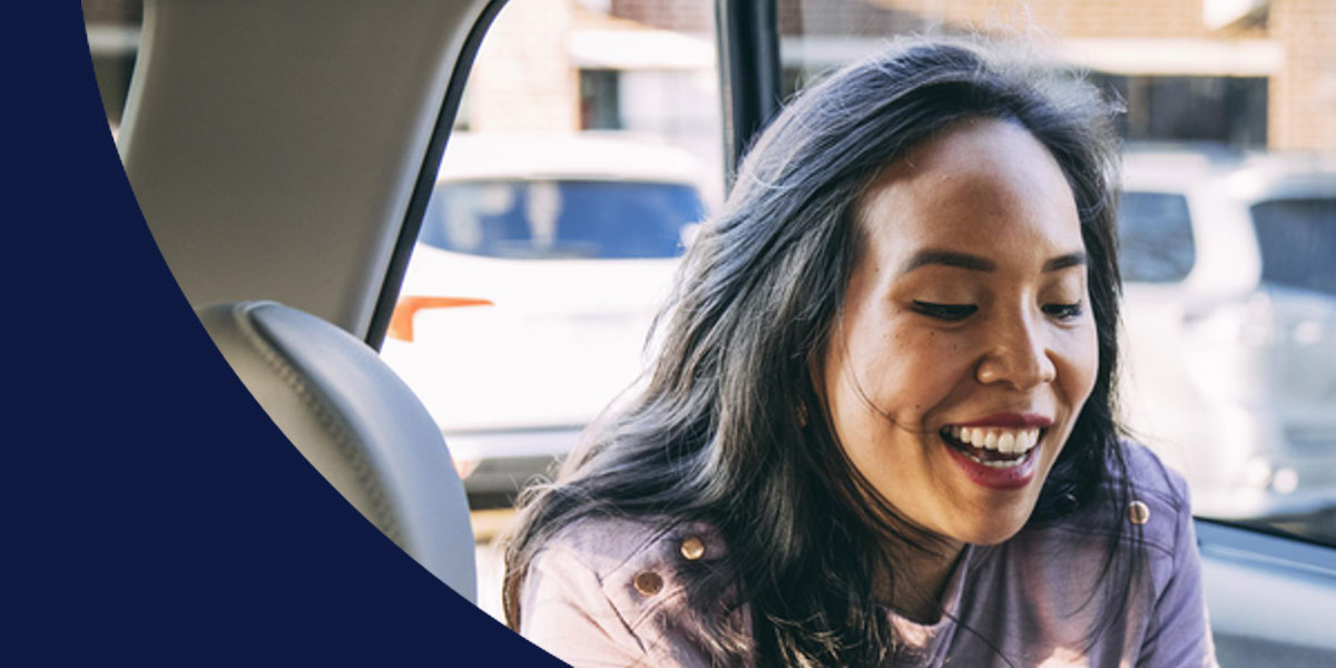 Woman smiling in the back seat of car